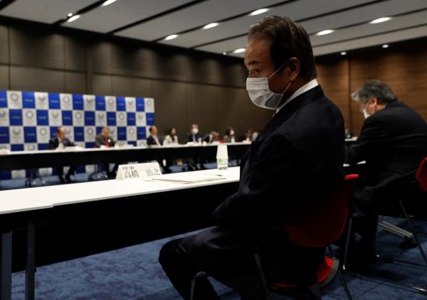 Haruyuki Takahashi wears a face mask during a Tokyo 2020 executive board meeting on the COVID-19 coronavirus outbreak on March 30, 2020. 